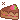 pixel art of a slice of chocolate cake. it is topped with a strawberry.