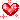 pixel art of a red heart covered in white and light red glitter.